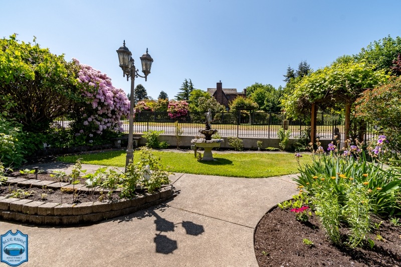 Fenced garden with walking paths of Blue Ridge Adult Family Home